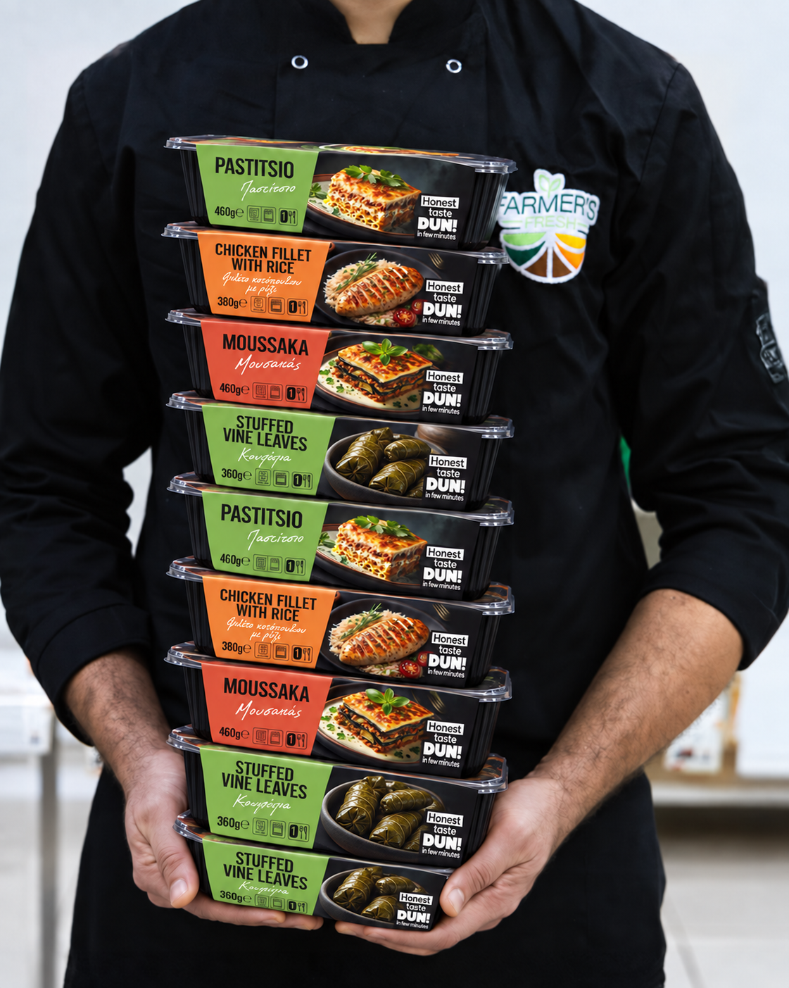 Farmer’s Fresh chef holding a stack of DUN! meals